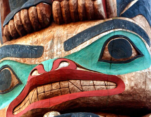 A close up of a totem pole.