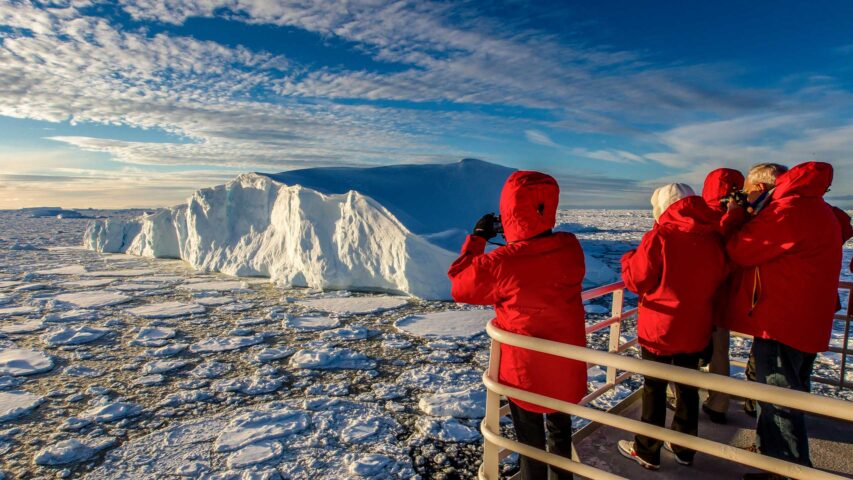 A group of people on an expedition ship in Antartica.