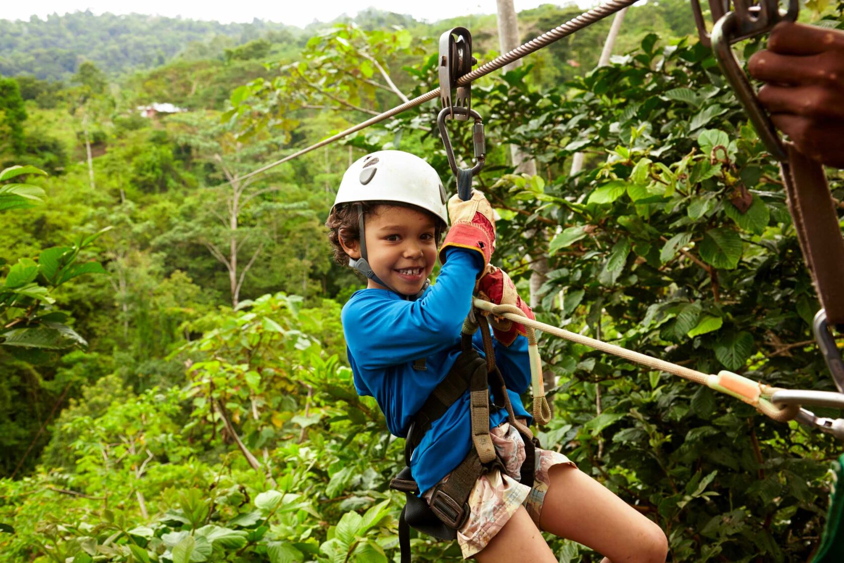 A boy riding a zipline.