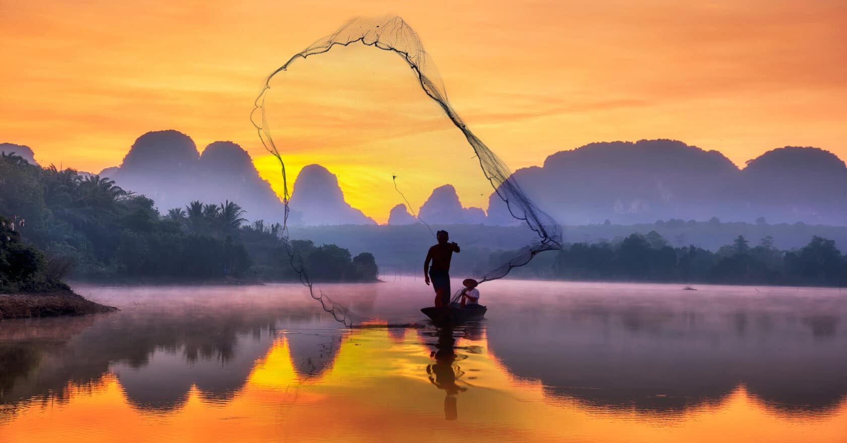 Silhouette fisherman A silhouette fisherman throw a net to catch a fish in a river with morning sun