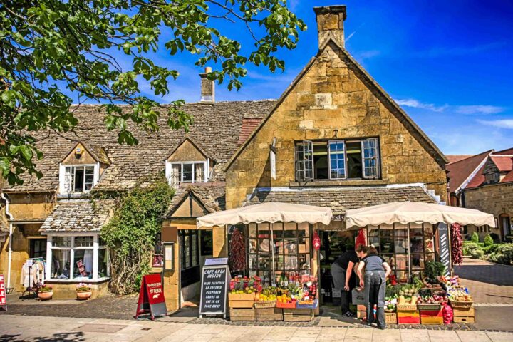 People outside the grocers store in Broadway, UK.