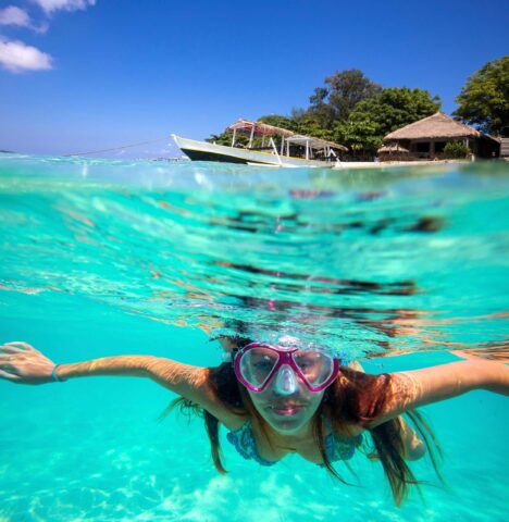 A close up of a woman snorkeling.