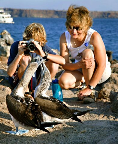 A mother and son watching birds.