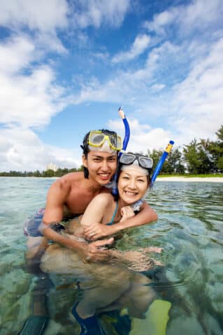 A couple with scuba diving gear.