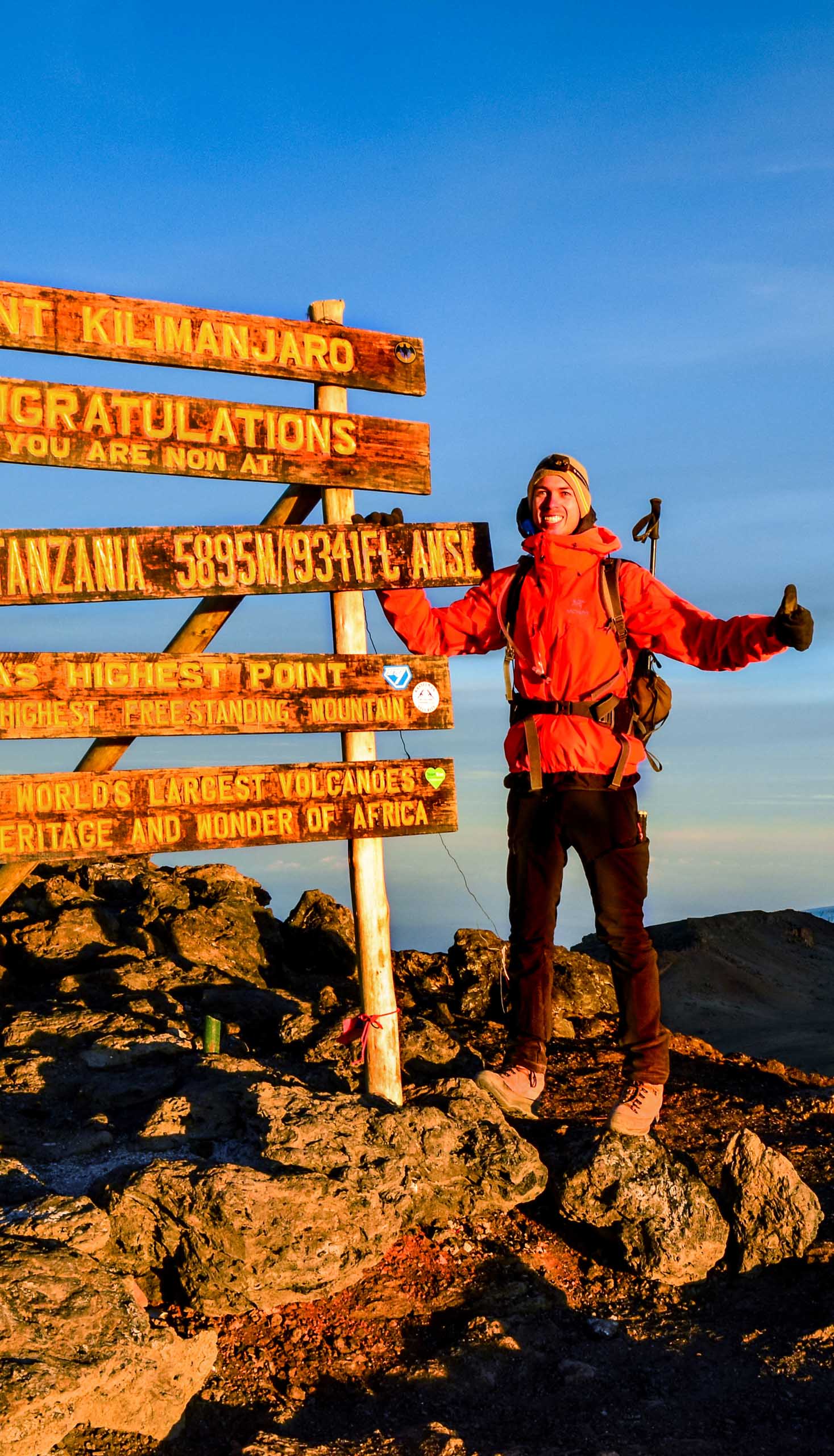 A hiker at the peak of Kilimanjaro.