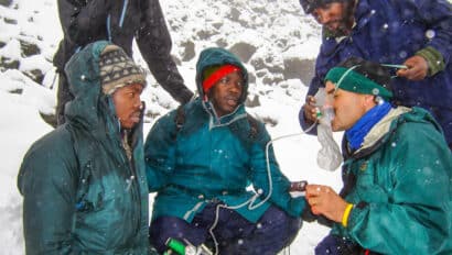 A man using an oxygen mask at Mt. Kilimanjaro.