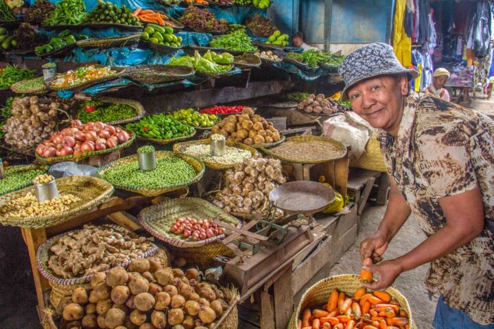 A person selling produce in a market in Madagascar.