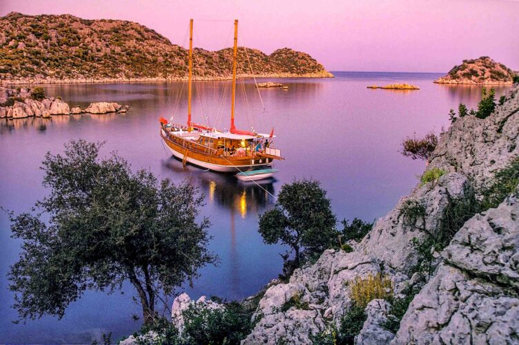 A sailing cruise boat at sunset.